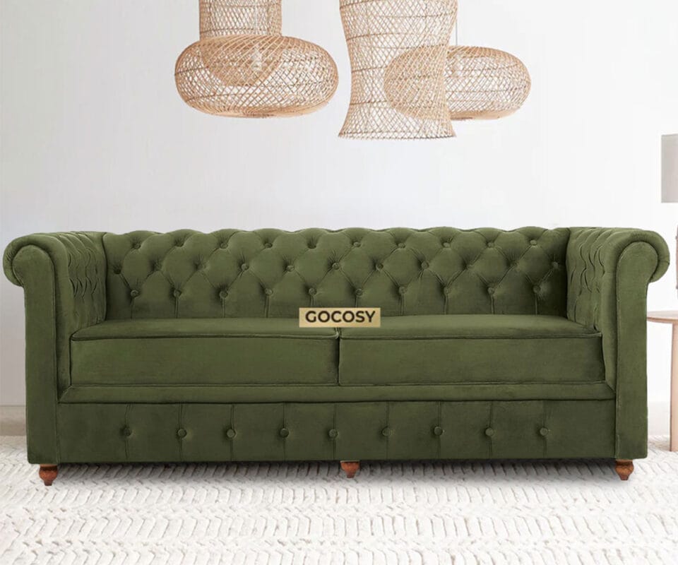 Luxurious Olive Green Velvate Chesterfield sofa with deep button tufting, rolled arms, and nailhead trim, adding a classic touch to a living room.