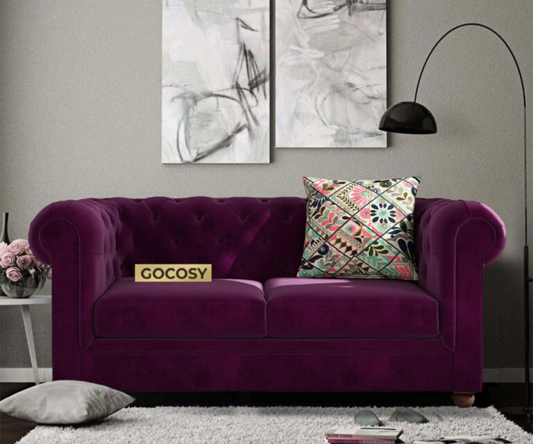 Luxurious Wine Red Velvet Chesterfield sofa with deep button tufting, rolled arms, and nailhead trim, adding a classic touch to a living room.