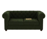 Luxurious Dark Forest Green Chesterfield sofa with deep button tufting, rolled arms, and nailhead trim, adding a classic touch to a living room.