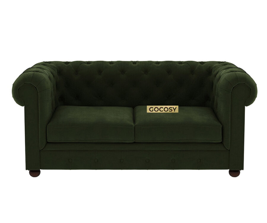 Luxurious Dark Forest Green Chesterfield sofa with deep button tufting, rolled arms, and nailhead trim, adding a classic touch to a living room.
