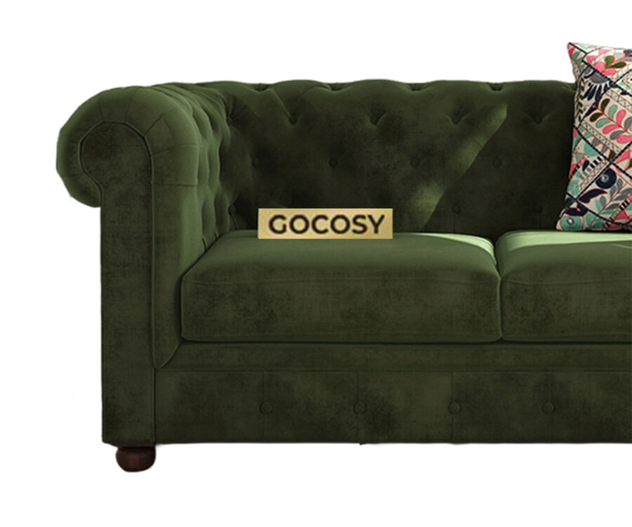 Luxurious Dark Forest Green Chesterfield sofa with deep button tufting, rolled arms, and nailhead trim, adding a classic touch to a living room.