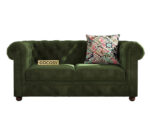 Luxurious Dark Forest Green Chesterfield sofa with deep button tufting, rolled arms, and nailhead trim, adding a classic touch to a living room.