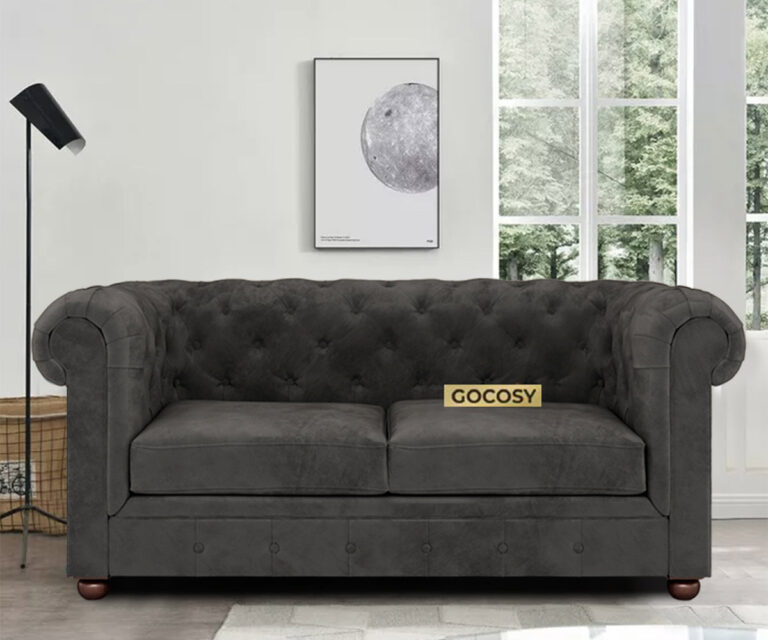 Luxurious Payne's Grey Velvate Chesterfield sofa with deep button tufting, rolled arms, and nailhead trim, adding a classic touch to a living room.
