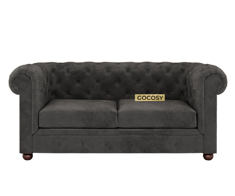 Luxurious Payne's Grey Velvate Chesterfield sofa with deep button tufting, rolled arms, and nailhead trim, adding a classic touch to a living room.