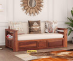 Elegant solid wood sofa cum bed with plush cushions, sturdy frame, and space-saving design by wood mount
