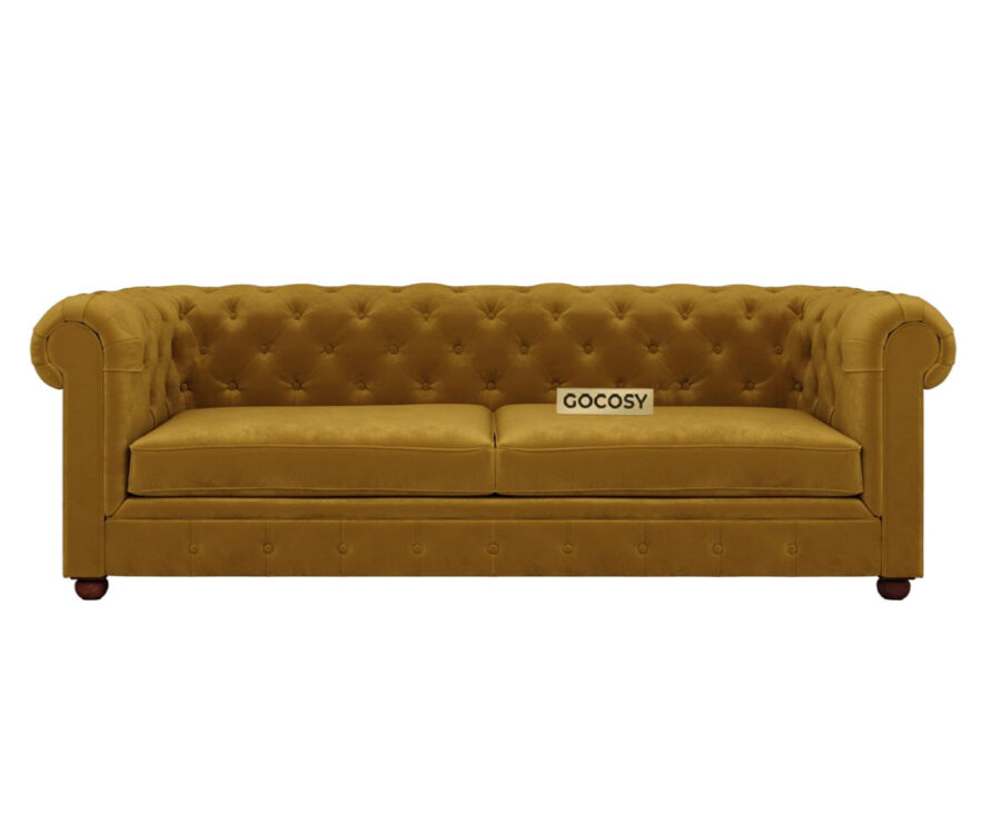 Luxurious Hunyadi Yellow Velvate Chesterfield sofa with deep button tufting, rolled arms, and nailhead trim, adding a classic touch to a living room.