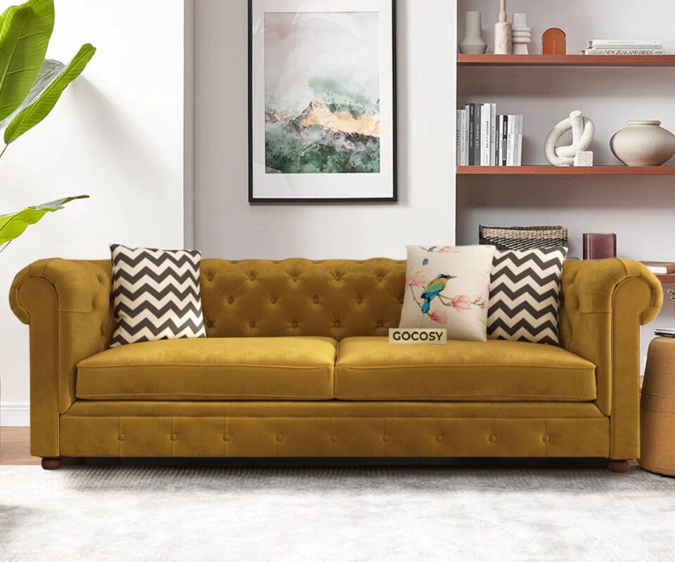 Luxurious Hunyadi Yellow Velvate Chesterfield sofa with deep button tufting, rolled arms, and nailhead trim, adding a classic touch to a living room.