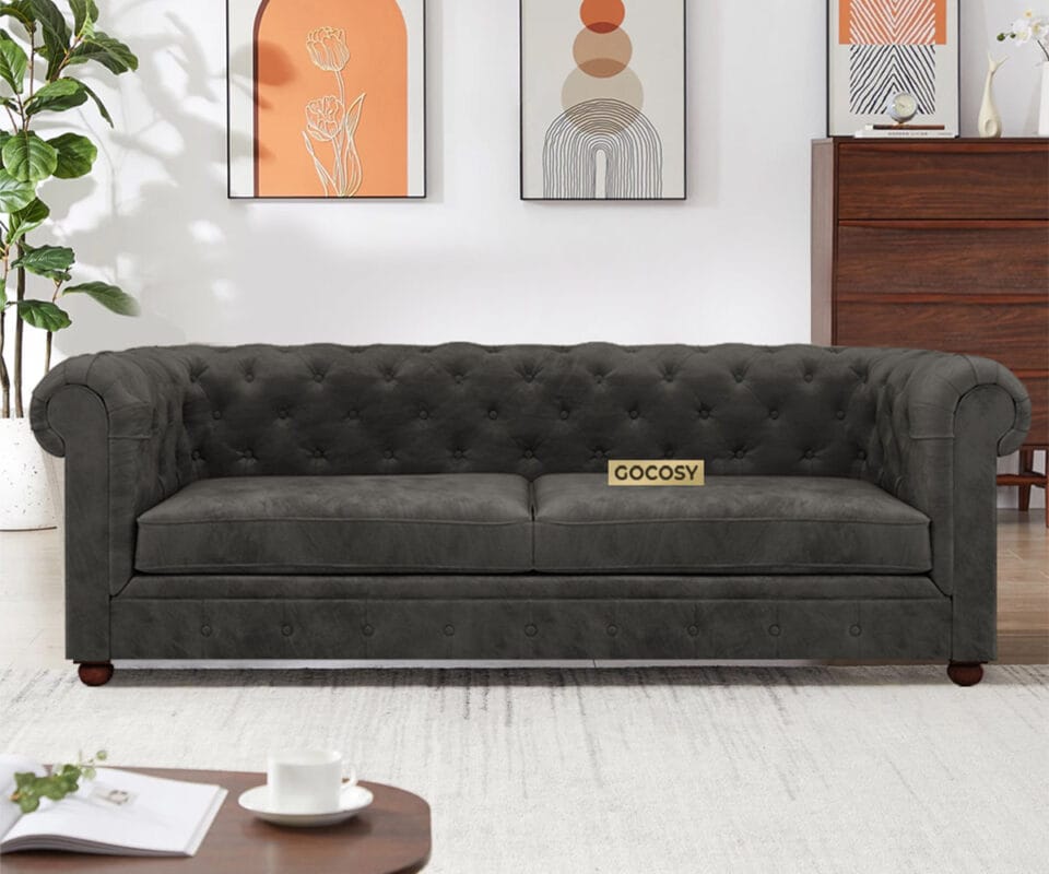 Luxurious Payne's Grey Velvet Chesterfield sofa with deep button tufting, rolled arms, and nailhead trim, adding a classic touch to a living room.